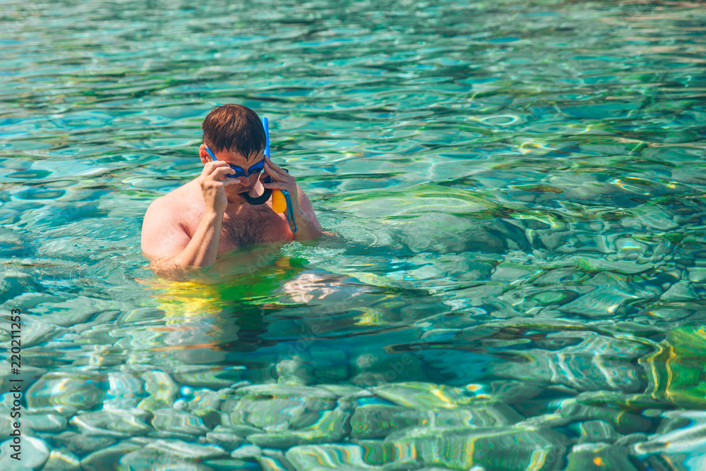 man swimming under water with mask and action camera