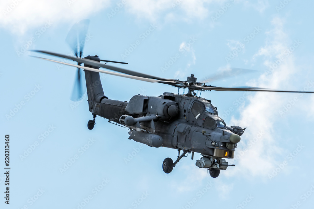 Military helicopter in the sky on a combat mission with weapons.