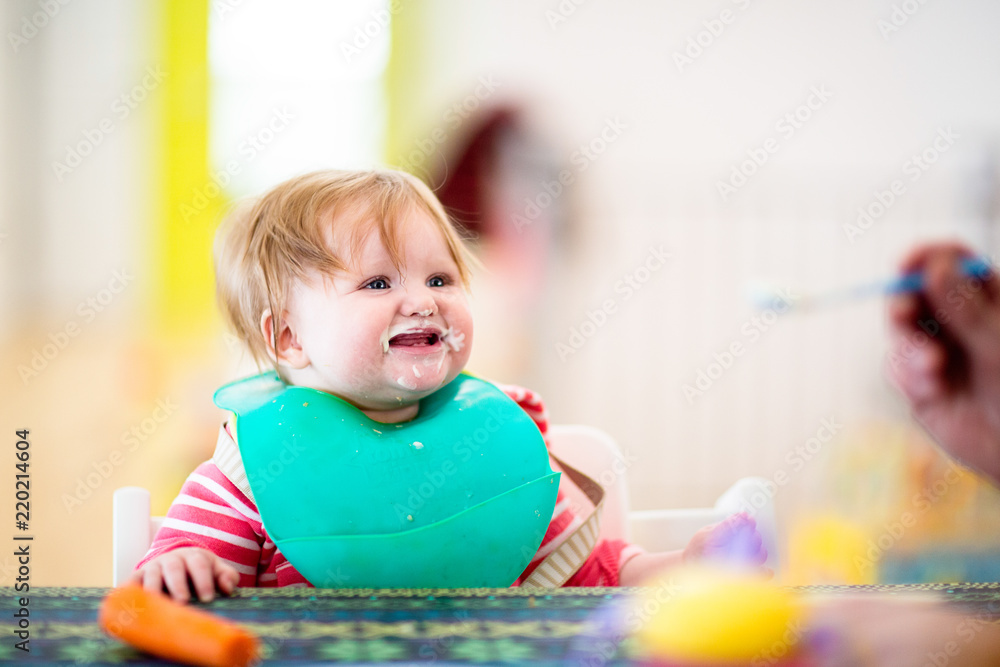 Fototapeta premium 8 month old girl eating dinner