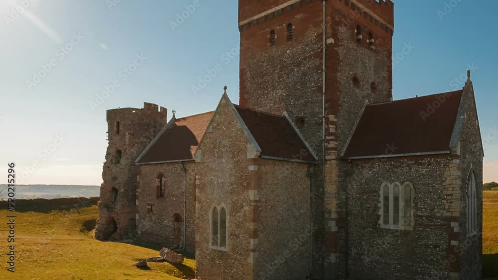 Establishing shot of the St Mary in Castro Saxon church built right next to a Roman lighthouse in Dover, Kent, England Establishing shot of the St Mary in Castro Saxon church built right next to a Roman lighthouse in Dover, Kent, England