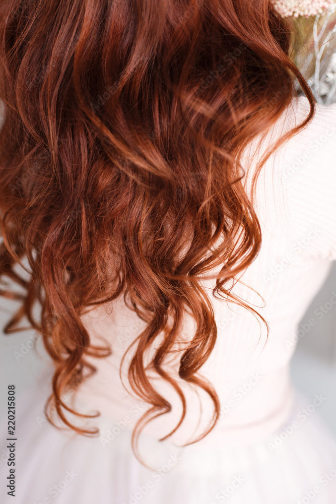 Naklejka premium Long-haired girl with curly red hair. Hair falls from the shoulders. Hair up to priests.