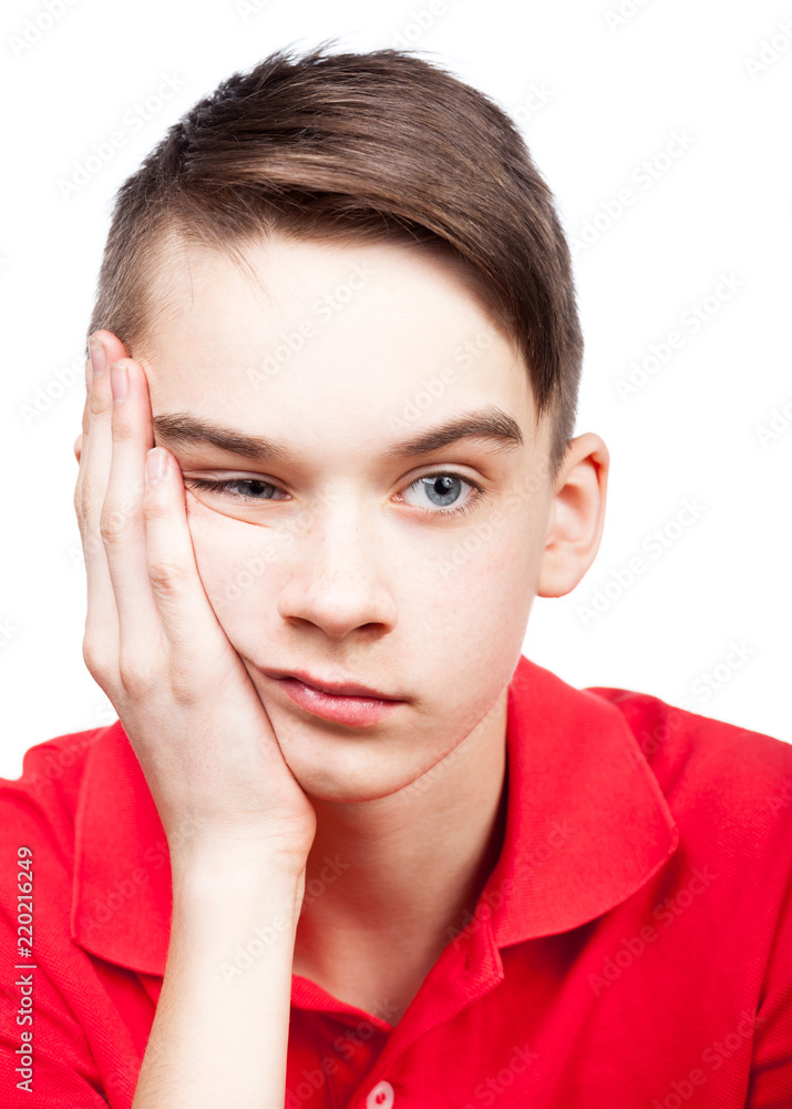 Bored teen boy with head on hand isolated on white Bored teen boy with head on hand isolated on white