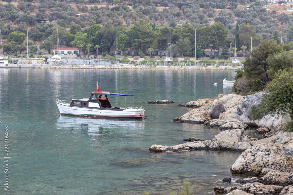 Obraz premium Perspective shoot of fishing boat on the small harbor of Mediterranean sea in Turkey
