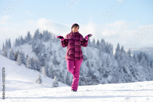 Woman enjoying scenery winter snowy landscape in Austrian Apls in ski areal