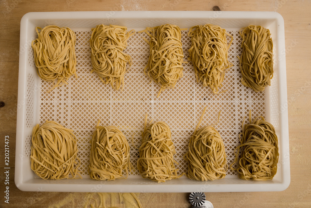 Overhead shot of rows of freshly made pasta. - obrazy, fototapety, plakaty 