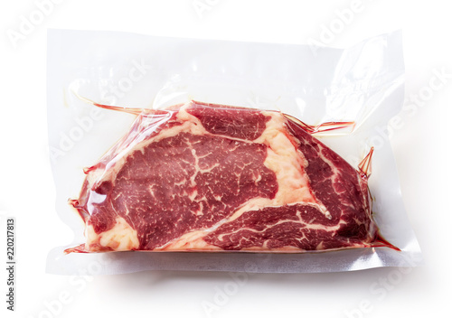 Canvas Print Beef steak vacuum sealed isolated on white, from above