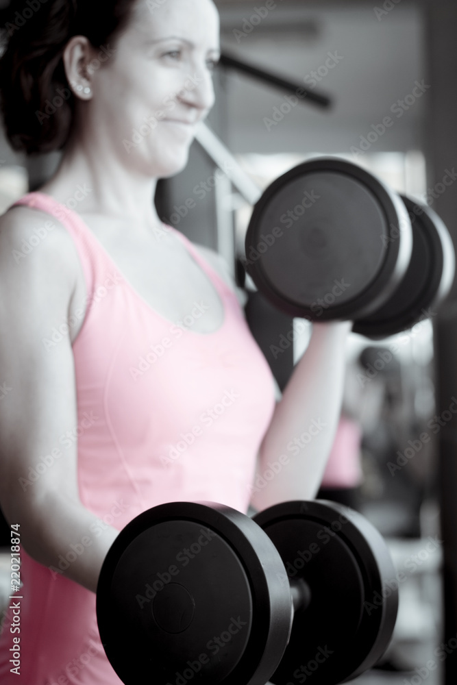 Thin thirties woman doing exercise in the gym Thin thirties woman doing exercise in the gym
