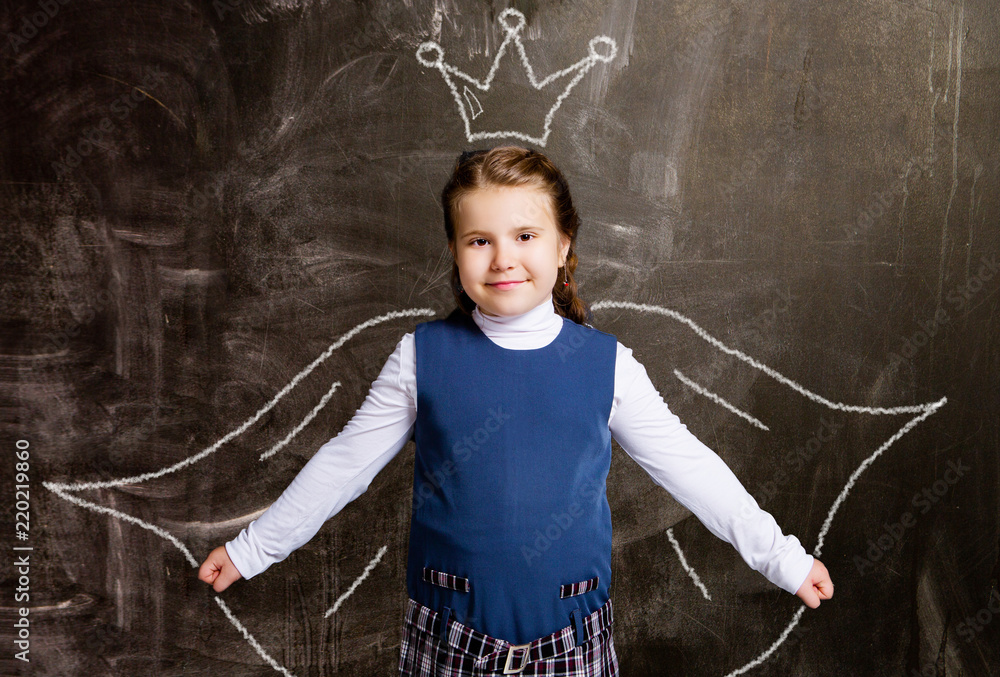 schoolgirl against chalkboard, with drawn crown and cloak