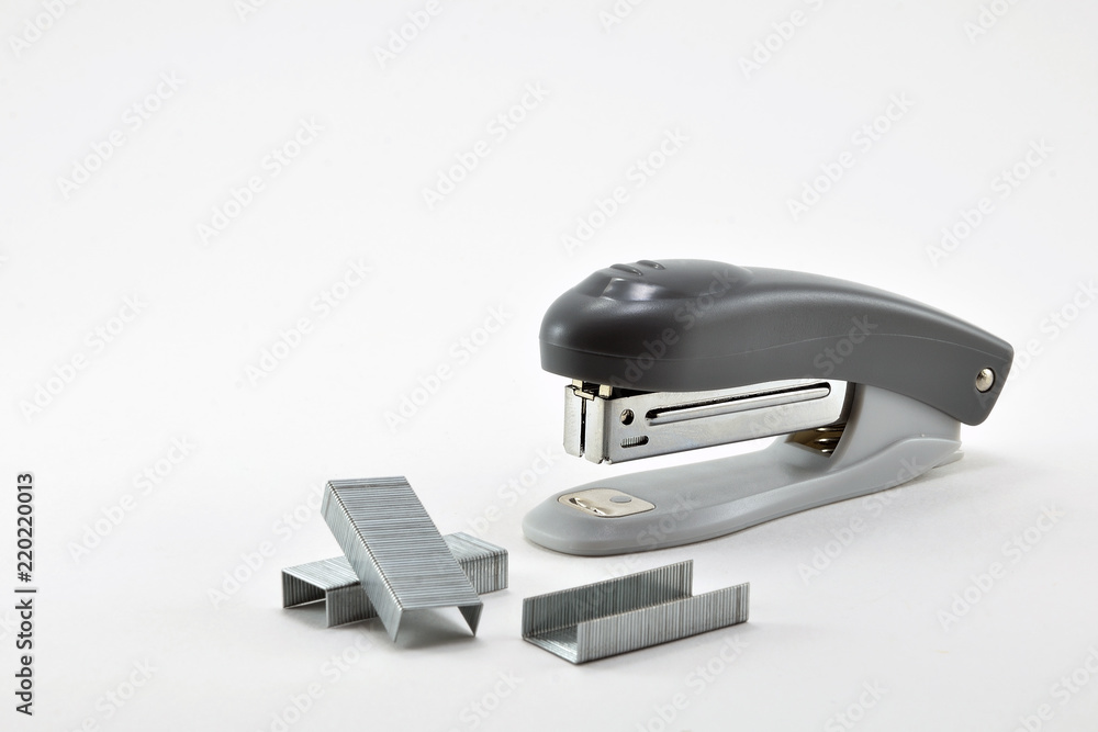 Stationery stapler and metal staples on white background. Stationery stapler and metal staples on white background.