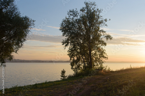 Trees beside lake in Votkinsk at sunset