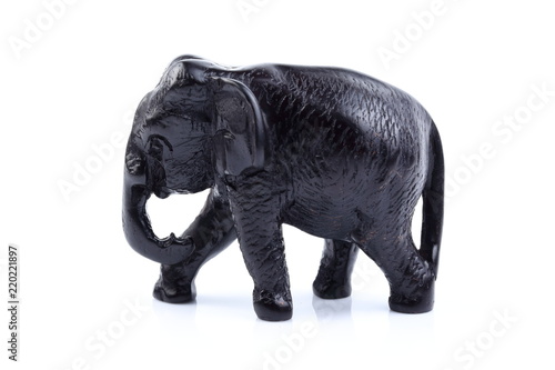 Black elephant like wooden carving with white ivory. Stand on white background  Isolated  Art Model Thai Crafts  For decoration Like in the spa.