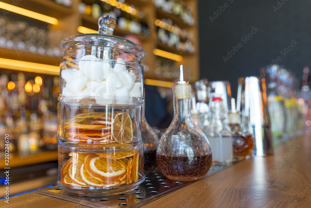 Classic bar counter with bottles in blurred background Classic bar counter with bottles in blurred background