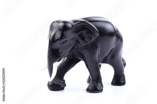 Black elephant like wooden carved with white ivory. Stand on white background  Isolated  Art Model Thai Crafts  For decoration Like in the spa.