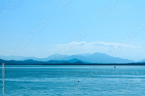 Layers of mountains by the sea in a calm landscape. Concept of peace and tranquility. Antonina, Paraná, Brasil.