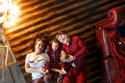 Parents and the child lie on the floor. View from above