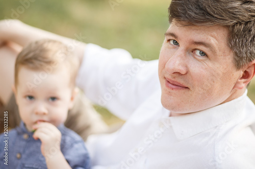 Father and child are sitting in a park