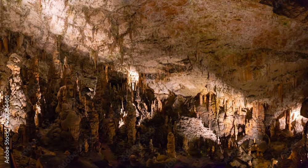 View of stalactites and stalagmites in an underground cavern - Postojna cave in Slovenia