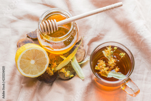 Tea with Linden, honey and Lemon. The tray on the bed, the Concept of the treatment of colds