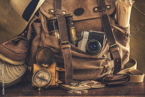 Looking image of the travelling concept, essential vacation items. Backpack. Retro effect.