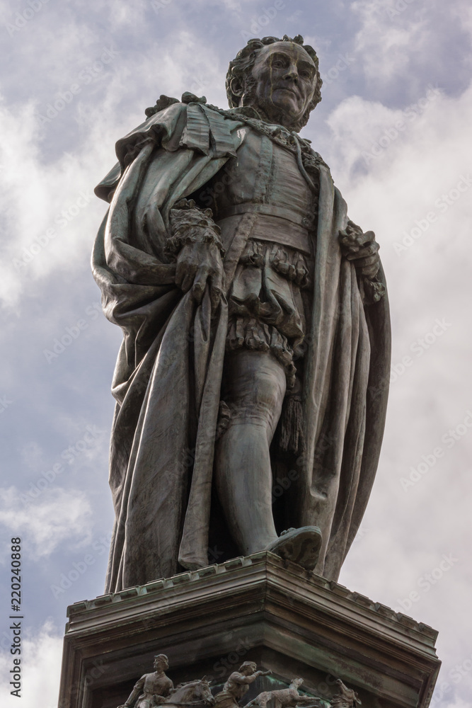 Edinburgh, Scotland, UK - June 14, 2012; Fish eye shot on Statue of Walter Montagu Douglas Scott, Duke of Buccleuch on Parliament Square. cloudscape.