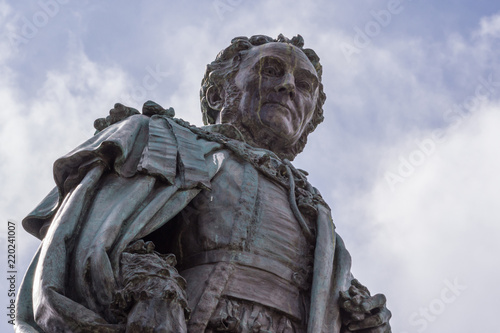 Edinburgh, Scotland, UK - June 14, 2012; Fish eye shot on chest and head of Statue of Walter Montagu Douglas Scott, Duke of Buccleuch on Parliament Square. cloudscape. photo