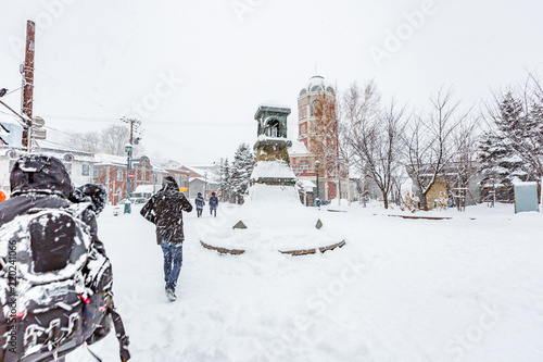 Fototapeta Naklejka Na Ścianę i Meble -  The peoples walking in the street during a snow storm in winter