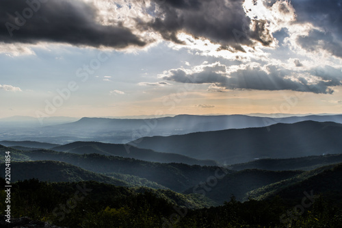 Shenandoah Valley National Park on a hazy summer day as the light breaks through the clouds casting shafts of light