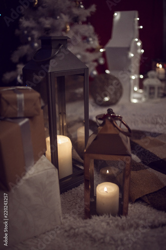 Christmas gifts and candles in lanterns
