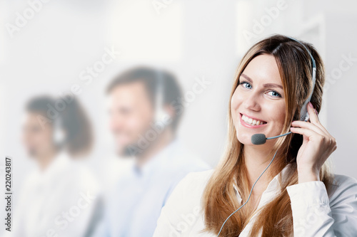 Happy and smiling woman with microphone during telemarketing job photo