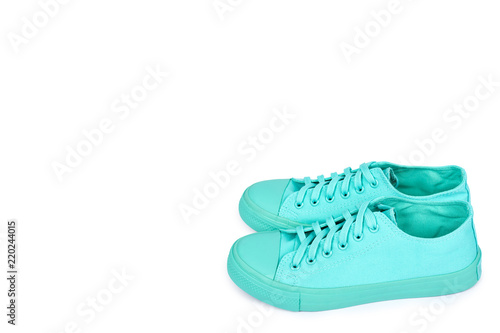 Turquoise rubber sneakers, casual footwear isolated on white background, copy space template
