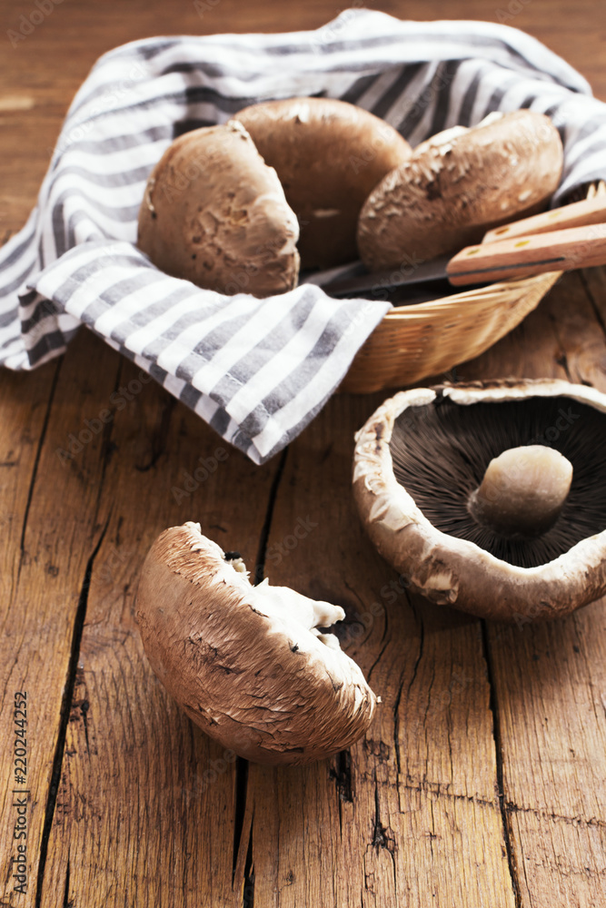 Portobello mushrooms on a wooden table. Selective focus. Copy space. Portobello mushrooms on a wooden table. Selective focus. Copy space.