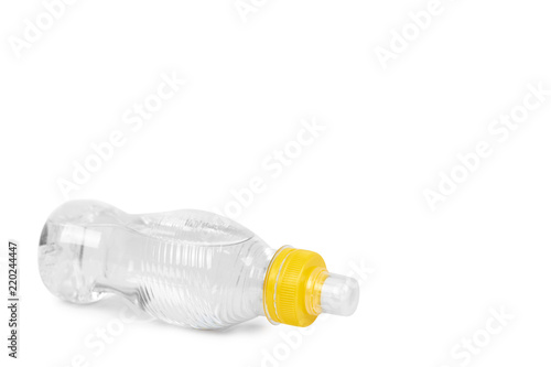 Transparent water bottle with yellow cap isolated on white background, copy space template