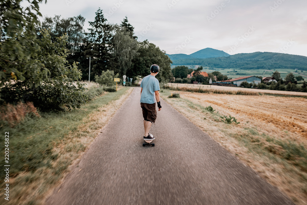 the guy is riding longboard the guy is riding longboard