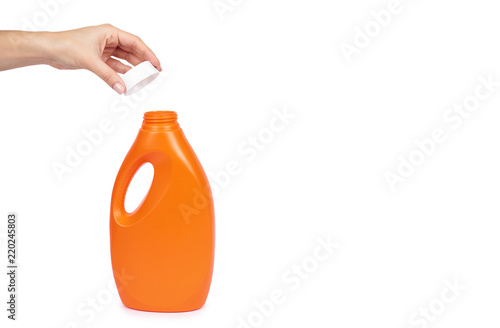 Orange plastic detergent bottle with hand isolated on white background, copy space template photo