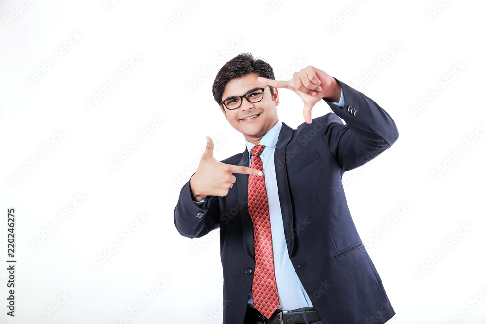 Young Indian businessman doing a frame sign Young Indian businessman doing a frame sign
