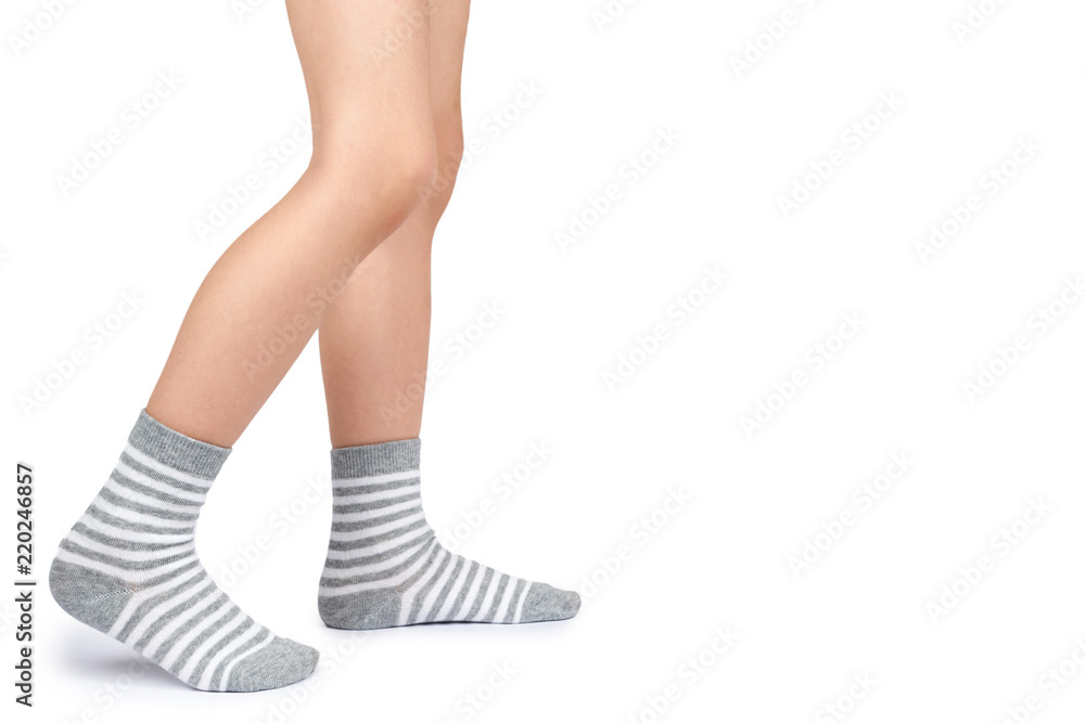 Kid legs in striped socks isolated on white background, copy space template