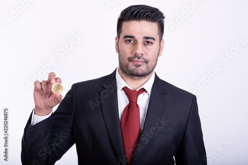 Businessman holding golden bitcoin isolated.