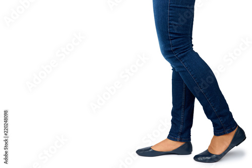 Female leg in jeans and leather shoes isolated on white background, copy space template © Sviatoslav Kovtun
