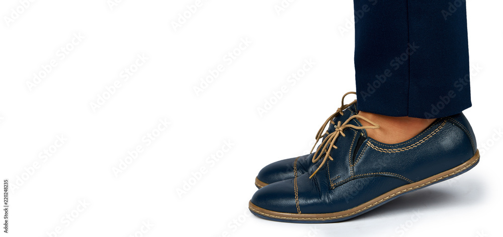Female leg in pants and leather shoes isolated on white background, copy space template