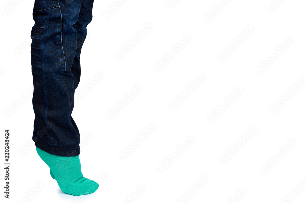 Kid legs in colored socks on leg isolated on white background, copy space template Kid legs in colored socks on leg isolated on white background, copy space template