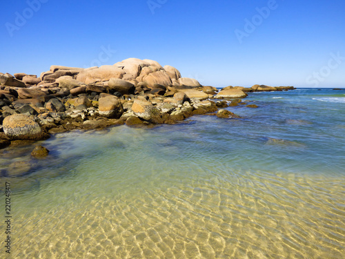 Rocky shore and transparent waters at Praia da Galheta (Galheta beach) in Florianopolis, Brazil