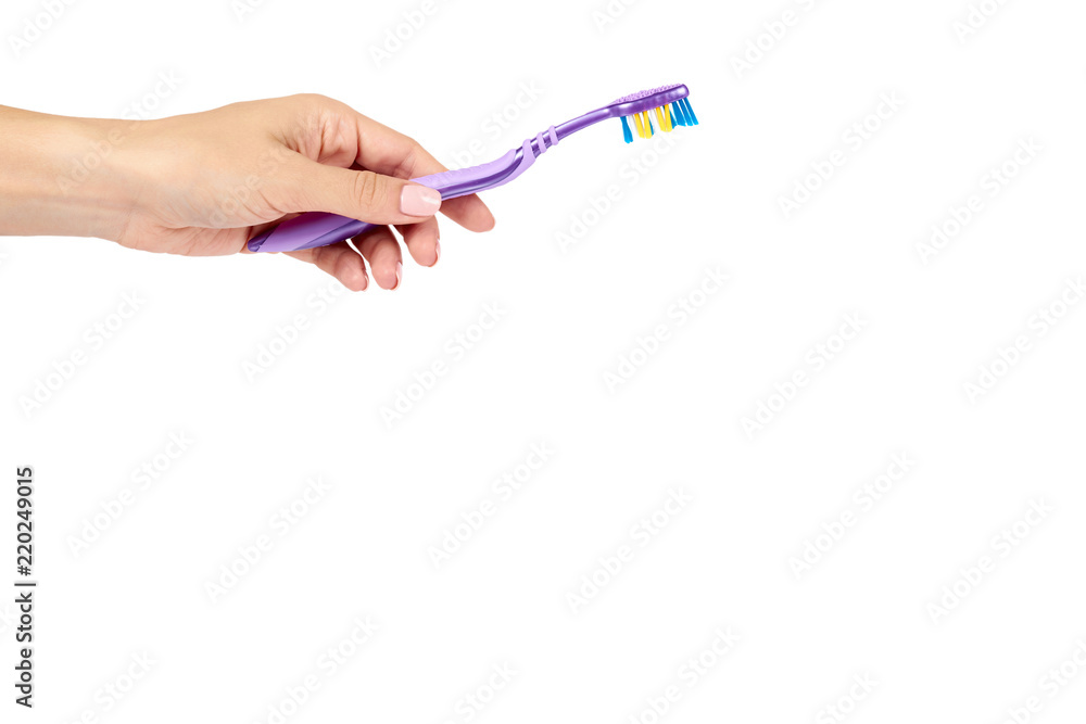 Color new toothbrush with hand isolated on a white background, copy space template. Color new toothbrush with hand isolated on a white background, copy space template.