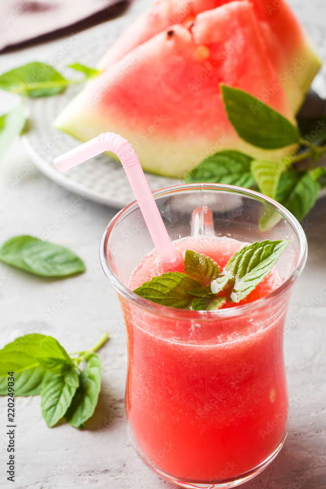 Fresh watermelon smoothie with ice and mint leaves in glasses. Fresh watermelon smoothie with ice and mint leaves in glasses.