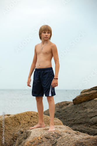 Boy practicing karate on the seashore