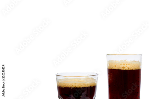 Cold glass of dark beer or kvass with foam isolated on white background, copy space template.