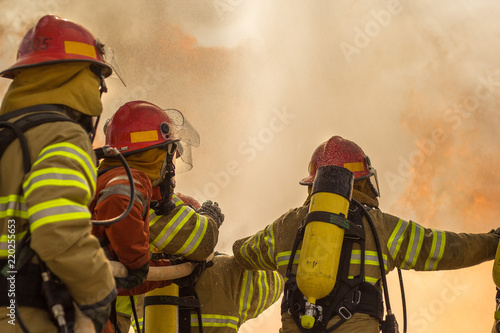 Some firemen fighting a great fire. Firefighters doing some training.
