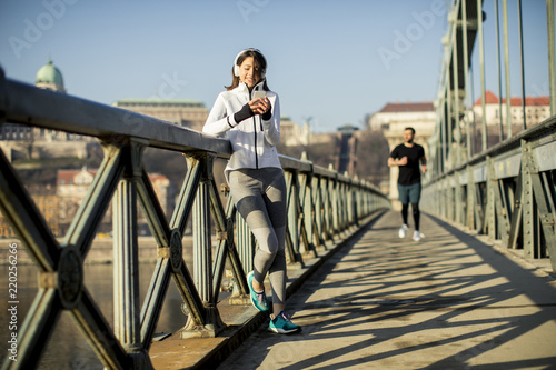 Woman on the bridge making a pause after the exercise