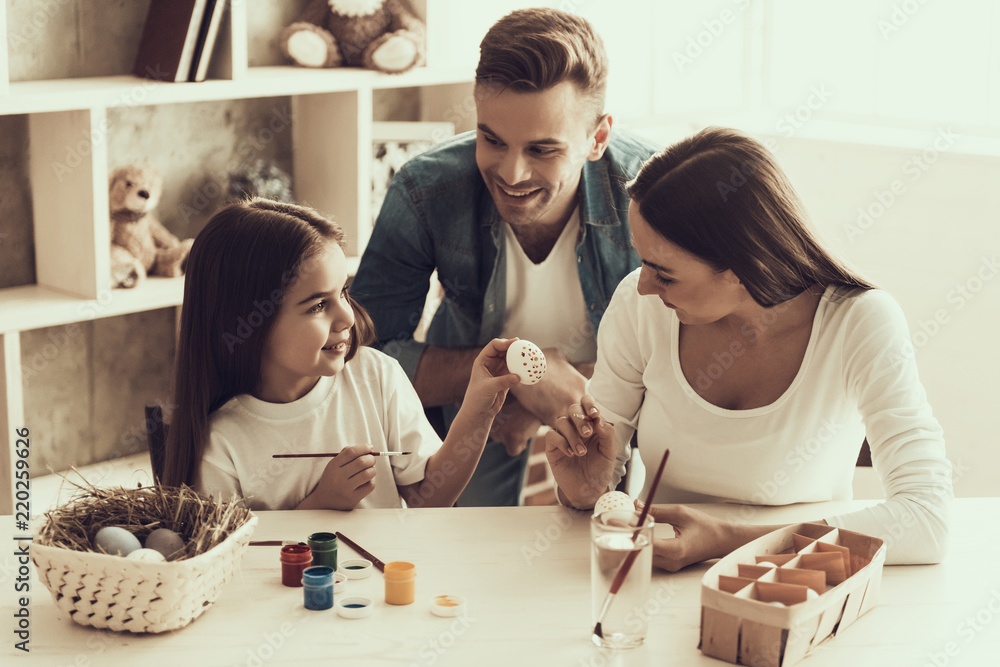Little Girl with Young Parents Painting Eggs Little Girl with Young Parents Painting Eggs