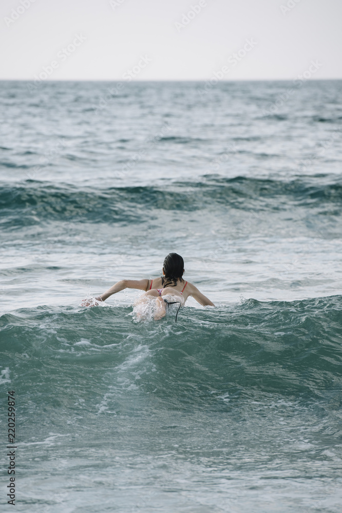 Young woman surfing the wave on his surfboard Young woman surfing the wave on his surfboard