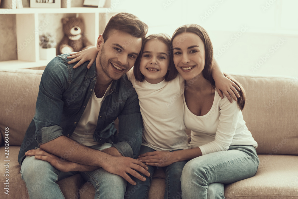 Portrait of Young Happy Family Sitting on Sofa Portrait of Young Happy Family Sitting on Sofa